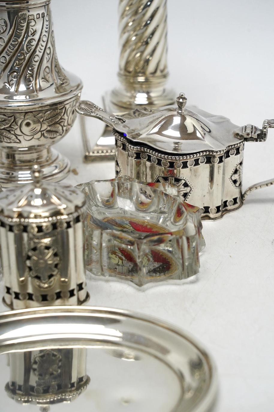 A 1970's silver sugar caster, a modern silver three piece condiment set, a silver oval dish and four other items including a pair of silver plated dwarf candlesticks. Condition - poor to fair